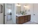 Bathroom featuring double vanity with marble countertop, modern fixtures, and hardwood cabinets at 4203 Walker Rd, Charlotte, NC 28211