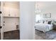 Bedroom entryway showing laundry area featuring tile floors with white cabinets at 4203 Walker Rd, Charlotte, NC 28211