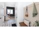 Inviting hallway with a decorative bench, convenient hooks, and stylish flooring at 4203 Walker Rd, Charlotte, NC 28211