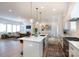 Open-concept kitchen with island seating seamlessly connecting to the living and dining areas at 4203 Walker Rd, Charlotte, NC 28211