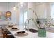Bright kitchen with stainless steel appliances, white cabinets, and pendant lighting over the island at 4203 Walker Rd, Charlotte, NC 28211