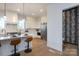 Modern kitchen featuring an island with pendant lights and a convenient powder room nearby at 4203 Walker Rd, Charlotte, NC 28211