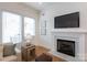 Cozy living area featuring a fireplace, with large windows and stylish decor at 4203 Walker Rd, Charlotte, NC 28211
