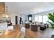 Bright open-concept living space with wood floors, a cozy seating area, and access to a staircase at 4203 Walker Rd, Charlotte, NC 28211