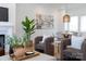 Bright living area with a modern painting, indoor plants and a comfortable sitting area at 4203 Walker Rd, Charlotte, NC 28211