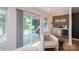 Cozy living room with glass sliding door, balcony access, and wet bar featuring patterned backsplash at 4203 Walker Rd, Charlotte, NC 28211