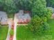 Bird's eye view of a brick home, featuring lush landscaping and a spacious driveway at 4644 Snow Dr, Harrisburg, NC 28075