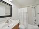 Clean bathroom features a shower-tub combo with neutral shower curtain and vanity with stainless steel faucet at 4644 Snow Dr, Harrisburg, NC 28075