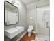 Modern bathroom featuring white herringbone tiles, a sleek sink, and a glass-enclosed shower at 4644 Snow Dr, Harrisburg, NC 28075