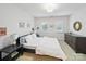 A light, neutral bedroom with a large bed, shutters, and side tables on each side at 4644 Snow Dr, Harrisburg, NC 28075