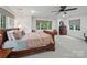Bright bedroom features a large window and stylish bed with colorful paisley patterned bedding at 4644 Snow Dr, Harrisburg, NC 28075