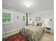 Bedroom with a bed with floral bedding, large windows, and a patterned rug at 4644 Snow Dr, Harrisburg, NC 28075