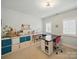 Bonus room with a craft table, storage cubes, and large windows at 4644 Snow Dr, Harrisburg, NC 28075