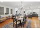 Open dining room showcasing hardwood floors, chandelier, and view to the kitchen at 4644 Snow Dr, Harrisburg, NC 28075