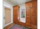 Well-organized entryway with wooden cabinets, a window seat, and a textured rug at 4644 Snow Dr, Harrisburg, NC 28075