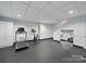 Home gym with exercise equipment, rubber flooring, and access to lower level of home at 4644 Snow Dr, Harrisburg, NC 28075
