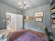 A home office featuring an open door, stylish decor, and an adjacent staircase at 4644 Snow Dr, Harrisburg, NC 28075