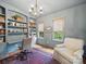 Office space with custom built-ins, hardwood floors, designer chandelier and natural light at 4644 Snow Dr, Harrisburg, NC 28075