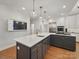 Spacious kitchen island with white marble countertop, a built in stovetop, and stainless steel appliances at 4644 Snow Dr, Harrisburg, NC 28075