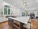 Open kitchen with a large center island, stainless steel appliances and open dining area at 4644 Snow Dr, Harrisburg, NC 28075