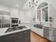 Modern kitchen featuring white cabinets, stainless steel appliances, and a large window for natural light at 4644 Snow Dr, Harrisburg, NC 28075