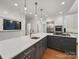 Modern kitchen featuring large island with barstool seating, stainless steel appliances and lighting at 4644 Snow Dr, Harrisburg, NC 28075