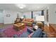 Bright living room featuring a stylish rug, sofa, and comfortable armchairs, perfect for relaxation at 4644 Snow Dr, Harrisburg, NC 28075