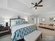 Spacious main bedroom with seating area features a large bed with floral bedding and a ceiling fan at 4644 Snow Dr, Harrisburg, NC 28075