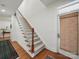 Elegant staircase with wooden railing and white balusters, leading to the upper level of the home at 4644 Snow Dr, Harrisburg, NC 28075