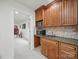 Convenient wet bar equipped with sink, mini-fridges, and wooden cabinetry perfect for entertaining at 4644 Snow Dr, Harrisburg, NC 28075