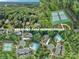 Aerial view of the community with multiple swimming pools, and tennis courts at 4672 Snow Dr, Harrisburg, NC 28075