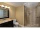 Updated bathroom showcasing a glass shower, modern vanity, and tiled floors at 4672 Snow Dr, Harrisburg, NC 28075