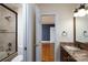 Bathroom with shower and granite countertop; door open to reveal the neighboring bedroom at 4672 Snow Dr, Harrisburg, NC 28075