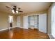 Bedroom with ceiling fan, closet with organizers, hardwood flooring, and an ensuite bath at 4672 Snow Dr, Harrisburg, NC 28075