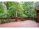 Spacious wooden deck with brown railings offering a beautiful view of the surrounding lush greenery at 4672 Snow Dr, Harrisburg, NC 28075
