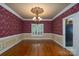 Formal dining room features decorative ceiling medallion, colorful wallpaper, and wainscoting at 4672 Snow Dr, Harrisburg, NC 28075
