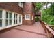 Home exterior with brick, windows, and a painted wood deck at 4672 Snow Dr, Harrisburg, NC 28075