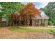 A beautiful two-story traditional brick home with a manicured lawn and mature trees at 4672 Snow Dr, Harrisburg, NC 28075
