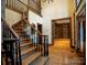 Spacious foyer boasts hardwood floors, elegant staircase, and an open view to the library at 4672 Snow Dr, Harrisburg, NC 28075