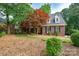 Traditional two-story brick home is enhanced by the vibrant landscaping and manicured lawn at 4672 Snow Dr, Harrisburg, NC 28075