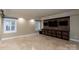 Finished basement game room with tile floor and storage at 4672 Snow Dr, Harrisburg, NC 28075