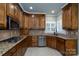 Modern kitchen showcasing stainless steel appliances, granite countertops, and custom cabinetry at 4672 Snow Dr, Harrisburg, NC 28075