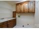 This laundry room has cabinet storage and a utility sink at 4672 Snow Dr, Harrisburg, NC 28075