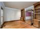 Bright sitting room with hardwood floors and built-in bookshelves opens to the dining room at 4672 Snow Dr, Harrisburg, NC 28075