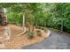 Beautiful driveway leads to landscaping and mature trees at 4672 Snow Dr, Harrisburg, NC 28075
