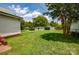 Spacious backyard featuring a large, well-maintained lawn and a detached garage at 505 S Eastway Dr, Troutman, NC 28166