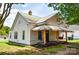 Charming home featuring a porch swing, awning, and well-maintained lawn at 505 S Eastway Dr, Troutman, NC 28166