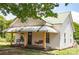 Attractive home exterior with a cozy porch, swing, and well-kept yard at 505 S Eastway Dr, Troutman, NC 28166