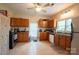Well-lit kitchen featuring wood cabinets and tile floor at 505 S Eastway Dr, Troutman, NC 28166