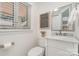 Powder bathroom featuring a vanity with marble countertop, mirror and decorative art at 5424 Doncaster Dr, Charlotte, NC 28211